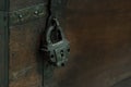 Reliable metal lock of the old design locks the bolt of an antique wooden chest, close-up, moonlight Royalty Free Stock Photo