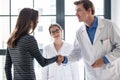 Reliable physician and female patient shaking hands before consultation Royalty Free Stock Photo