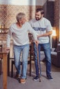 Reliable unshaken man helping retired and supporting him. Royalty Free Stock Photo