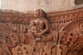 A relief art work women with a child on decorative piller of old palace of Indore