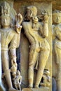 Relief carving of a Apsara or Nayika playing flute on the wall of Lakshmana Temple