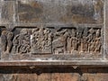 Relief carving of krishna playing flute and Hanuman and cow feeding her baby on the wall