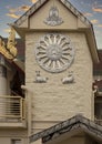 Relief of the dharma wheel above two sitting deer on the outside of the Buddhist Center of Dallas, Texas.