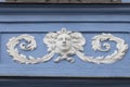 Relief on facade of old building, decorated woman`s face, Prague