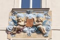 Relief on facade of old building, two cupids in blue ornamental motifs, Prague, Czech Republic