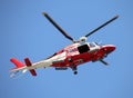 Relief Helicopter flies fast in the blue sky during the emergenc