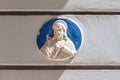 Relief of Jesus Christ on the facade of a historic limestone building, Birgu, Malta Royalty Free Stock Photo