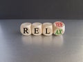 Relief and relax symbol. Turned cubes and changes the word Relief to Relax. Royalty Free Stock Photo