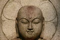 Smiling buddha face in stone Royalty Free Stock Photo