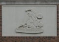 Relief with two men wrestling on the exterior of the National Wrestling Hall of Fame and Museum in Stillwater, Oklahoma.