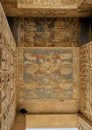 Relief with winged cobras and hieroglyphs  the ceiling of the passageway through the 2nd pylon of the Temple of Ramesses III. Royalty Free Stock Photo