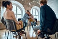 Relieved man and woman hugging giving psychological support empathy during a group therapy session, friends people embracing