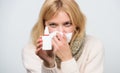 Relieving itchy nose. Cute woman nursing nasal cold or allergy. Sick woman spraying medication into nose. Treating