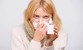 Relieving itchy nose. Cute woman nursing nasal cold or allergy. Sick woman spraying medication into nose. Treating