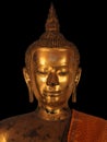 The ancient and damaged Buddha statue on the black background