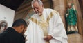 Religion, church and man with priest for communion for ceremony, service and sermon at altar. Catholic, praying and Royalty Free Stock Photo