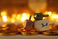 Religion concept of of jewish holiday Hanukkah with wooden dreidels spinning top and chocolate coins over wooden table and bokeh Royalty Free Stock Photo