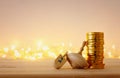 Religion concept of of jewish holiday Hanukkah with wooden dreidels spinning top and chocolate coins over wooden table and bokeh Royalty Free Stock Photo