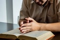 Religion concept, Young asian man reading bible and raising hands to prayer for believe in goodness Royalty Free Stock Photo