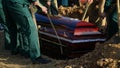 Religion, death and dolor - coffin bearer carrying casket at funeral to cemetery