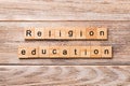 Religion education word written on wood block. religion education text on wooden table for your desing, concept