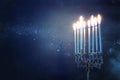 Religion image of jewish holiday Hanukkah background with menorah traditional candelabra and candles