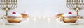 Religion image of jewish holiday Hanukkah background with spinning top and doughnut over white background