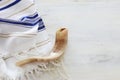 Religion image of shofar horn on white prayer talit. Rosh hashanah jewish New Year holiday, Shabbat and Yom kippur concept