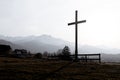 Religion theme, view of catholic cross silhouette, with fantastic sunset and mountains as background. Toned image Royalty Free Stock Photo