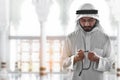 Religious arab muslim man praying with rosary bead