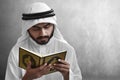 Religious arab muslim man reading holy quran