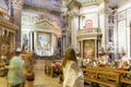 Religious architecture and tourist praying in Cathedral Santa Maria Assunta