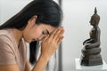 Asian buddhist woman having worship and pray with faith to buddha statue Royalty Free Stock Photo