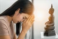 Asian buddhist woman having worship and pray with faith to buddha statue Royalty Free Stock Photo