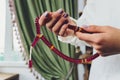 Religious Asian buddhist woman praying with hand holding rosary beads. Female buddhist disciple meditating, chanting