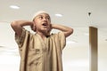 Religious asian muslim kid with cap praying Royalty Free Stock Photo