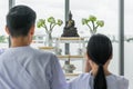 Religious buddhist asian couple in white clothing worship and pray to buddha