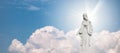 Mother Mary and Baby Jesus Statue against blue sky with white clouds background. Royalty Free Stock Photo