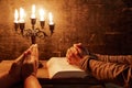 Religious female crossed hands in prayer with bible and candle Royalty Free Stock Photo