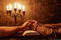 Religious female crossed hands in prayer with bible and candle Royalty Free Stock Photo