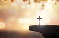 Christian holding the Holy Cross of Jesus Christ on autumn sunset background
