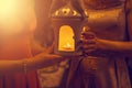 Religious concept. Two females hands holding a burning candle in Royalty Free Stock Photo