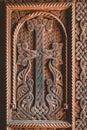religious cross carved in a wooden door at the entrance to an ancient Armenian church Royalty Free Stock Photo