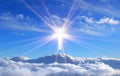 Religious cross over cumulus clouds illuminated by the rays of holy radiance, concept Royalty Free Stock Photo