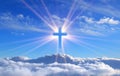 Religious cross over cumulus clouds illuminated by the rays of holy radiance, concept. Royalty Free Stock Photo