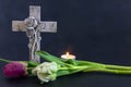 Ornate cross with tulip flowers on a dark background. Condolence card. Empty place for emotional sentimental quote. Royalty Free Stock Photo