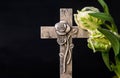 Ornate cross with tulip flowers on a dark background. Condolence card. Empty place for emotional sentimental quote. Royalty Free Stock Photo