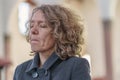 Religious devout woman praying alone in a church