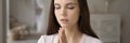 Religious dreamy young woman praying with hope wide image