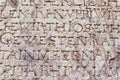 Religious engraved letters on stone wall Royalty Free Stock Photo